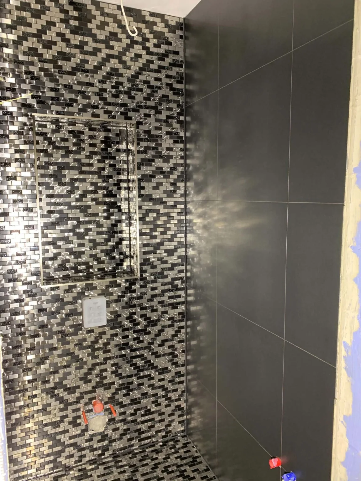 Real wall tiling work in Dublin with large-format tiles and mosaic detail