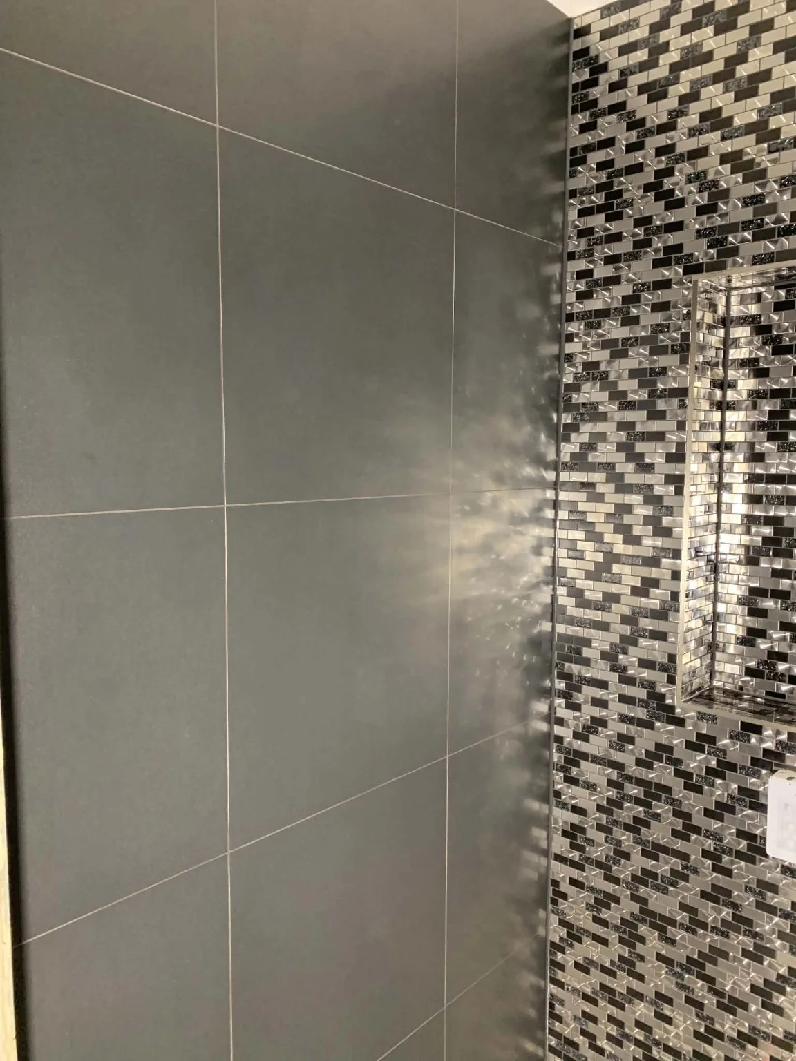 Real white brick-effect feature wall from our tiling work portfolio