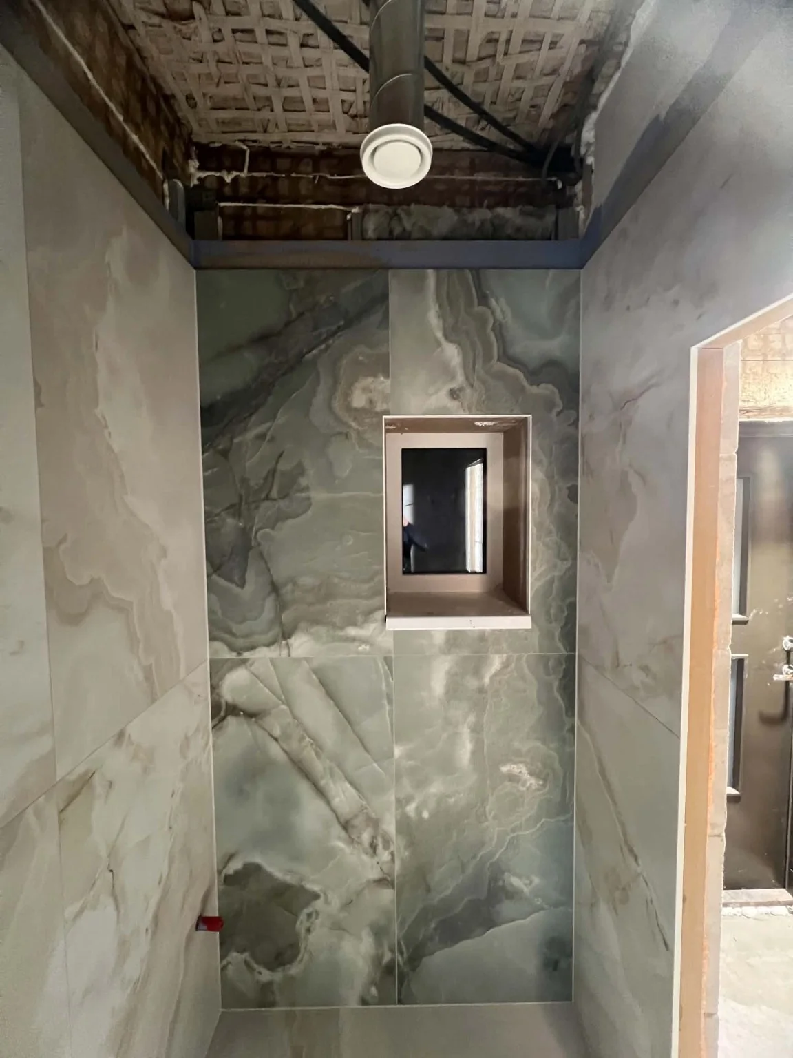 Real stone-effect statement wall from our tiling work portfolio